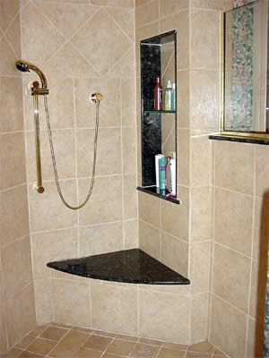 Private Residence, Chapel Hill. Fabricated of Verde Butterfly granite, this shower seat and wall niche are installed in a shower of porcelain tiles that mimic limestone.  These accent pieces tie in with an adjacent tub deck and vanities.