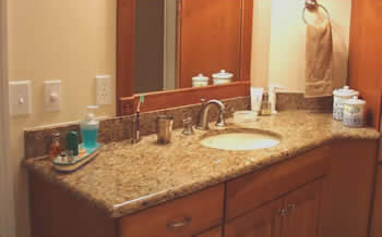 Private Residence, Chapel Hill. This vanity is Giallo Veneziano granite which is quarried in Brazil. The stone is gold with peach undertones and has lots of smoky, topaz quartz. The quartz blends beautifully with stainless steel and pewter.