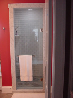 Private Residence, Chapel Hill. The addition of marble moulding around this Chapel Hill shower entry created an elegant detail that tied the shower to the vanity and tub deck. Though this appears simple in design, expert fabrication and installation of such a detail requires tremendous 