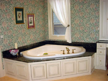 Private Residence, Chapel Hill. This tub deck, fabricated from 2cm (3/4") thick Verde Butterfly granite, was designed to accommodate a drop-in tub.  The splashes are usually six to eight inches in height on tubs and the plumbing fixtures can either be mounted on the stone or, sometimes 