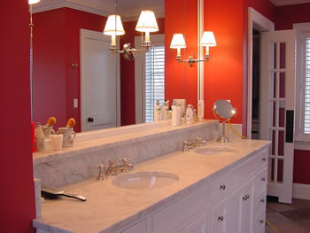 Private Residence, Chapel Hill. This elegant Master Bath Vanity in a Chapel Hill residence features a very traditional Italian marble known as Carrera. The rich wall colour creates a wonderful backdrop for the marble. An integrated shelf adds a detail that creates dimensional interest a