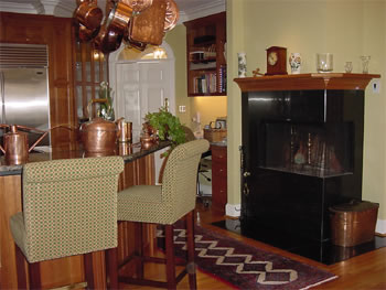 Private Residence, North Raleigh. This unusual corner fireplace surround is in the kitchen and is fabricated of Southern Black granite.  This granite is reminiscent of some of the marbles used on old soda fountains and has a soft, "old-timey" appearance.