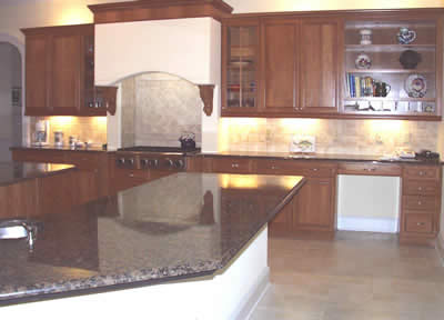 Private Residence, Chapel Hill. Baltic Brown granite, quarried in Finland, was used for the counter surfaces in this home. Close collaboration with the builder was required to execute the cooktop alcove.