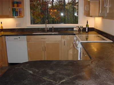 Private Residence, Durham. Ice Flower soapstone was selected for the tops in this house.  Once cured with mineral oil, the rich green veins become prominent and provide lots of visual interest in this kitchen.