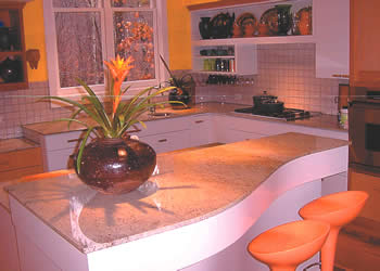 Private Residence, Durham. This designer kitchen features a grand piano island and was highlighted in the February/March issue of Better Homes & Gardens Remodeling Magazine. The granite is Kashmir White, from India, and the designer is Julie Staelin.