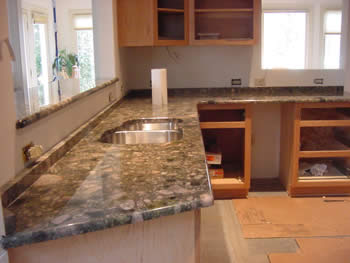 Private Residence, Orange County. Quartzites, such as this Verde Marinace, are even harder than granite! Verde Marinace was selected for this kitchen remodel in Orange County not only to bring elements of the outside into the house but also because it blends so beautifully with the cher