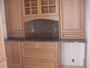 Private Residence. Use of a full-height backsplash at this Butlers Pantry showcases the beauty of very rich Baltic Brown granite. This stone, quarried in Finland, comes in a wide range of color from beige/gray to deep chocolate-black with forest green accents. The extra la