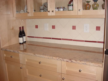 Private Residence. Shivakashi Peach, a variation of Shivakashi granite from India, was used in this kitchen. The tones, which varied from terracotta to peach to ivory blended well with the maple cabinets and tile splash. This stone, when accented with under cabinet lighting