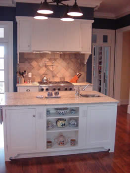 Private Residence, Chapel Hill. Evocative of an earlier era, the designer of this Chapel Hill kitchen initially specified marble for the counters. Instead, the clients selected Bianco Romano granite that is reminiscent of a white travertine. Use of the granite (as opposed to travertine)