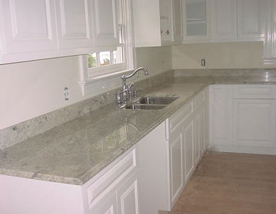 Private Residence, Raleigh. This residence, located inside the Raleigh Beltline, was upfitted using white cabinets with Bianco Romano granite and polished chrome plumbing fixtures.