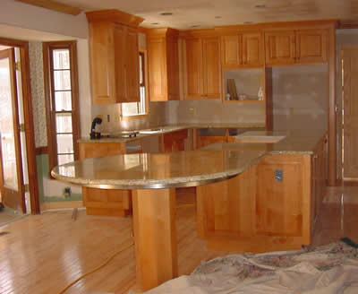 Private Residence, Raleigh. The granite is Bianco Romano New and it is quarried in Brazil. The use of Prescott Stones Factory Seam created the illusion of a huge single piece of stone all the way past the cooktop cut-out. It is only with the expertise of our highly skilled personn