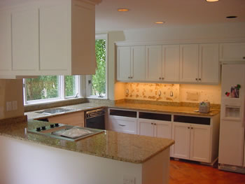 Private Residence, Chapel Hill. This kitchen renovation in Chapel Hill replaced the pre-existing solid surface with New Venetian Gold granite. Functionally, this enhanced the cooktop area as the granite performs very well near heat and will not scorch. The richness and depth of the New 