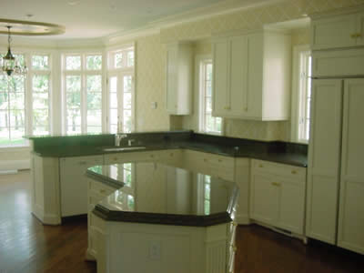 Private Residence, Mebane. Tropical Brown granite from Saudi Arabia. This kitchen combines the two standard granite thickness options by utilizing 3cm stone on the perimeter counters and laminated 2cm stone on the island (which yields a thickness of 4cm). Some of the details includ