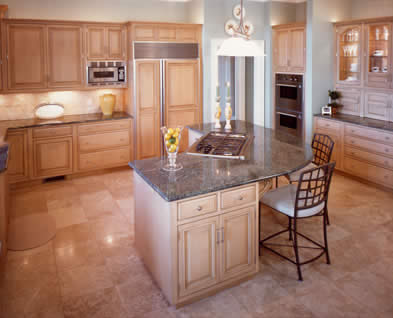 Private Residence, Chapel Hill. Verde San Francisco granite was selected for this kitchen due to its soft green-gray tones and beautiful, swirling movement. The slabs were just large enough to fabricate the island in one piece, eliminating the need for a seam. Decorative wood corbels ap