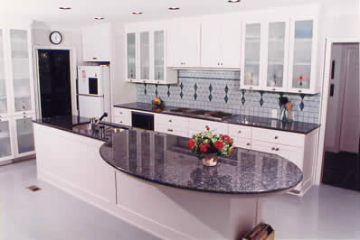 Private Residence, Chapel Hill. Blue Pearl granite, quarried in Norway, was used for the counters in this kitchen. The huge, curved overhang is supported by tubular steel that was designed, fabricated and installed by Prescott Stone Fabricators.