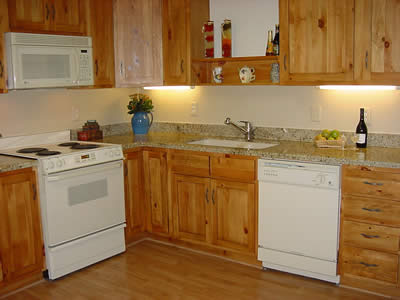 Private Residence, Chapel Hill. This Chapel Hill retirement villa was transformed when the kitchen was updated using distressed pine cabinets and 2cm New Venetian Gold granite counters.  New Venetian Gold is quarried in Brazil and this 2cm stone was laminated on the edges to create the 