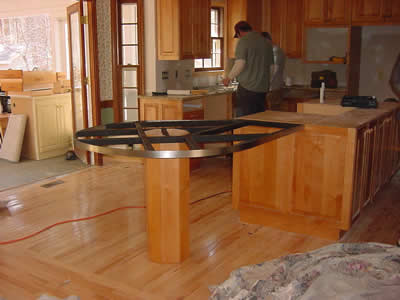 Private Residence, Raleigh. This image of a North Raleigh kitchen depicts the tubular steel substrate that supported a large peninsula.  Prescott Stone Fabricators provides custom designed and fabricated tubular steel supports for any overhangs. Most often, the steel is painted matt