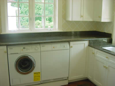 Private Residence, Mebane. Tropical Brown granite from Saudi Arabia with its deep walnut tones and three dimensional depth creates a practical and beautiful work area in this laundry home.  This home, built years ago, was recently renovated and updated.