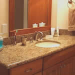 Private Residence, Chapel Hill. This vanity is Giallo Veneziano granite which is quarried in Brazil. The stone is gold with peach undertones and has lots of smoky, topaz quartz. The quartz blends beautifully with stainless steel and pewter.