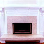 Private Residence, Durham. This fireplace was designed to be used from two rooms: the living room and master bedroom. This side, featuring the living room, has a cantilevered, raised hearth underneath which wood can be stored. Prescott Stone Fabricators designed and installed the s