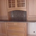 Private Residence. Use of a full-height backsplash at this Butlers Pantry showcases the beauty of very rich Baltic Brown granite. This stone, quarried in Finland, comes in a wide range of color from beige/gray to deep chocolate-black with forest green accents. The extra la