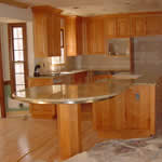 Private Residence, Raleigh. The granite is Bianco Romano New and it is quarried in Brazil. The use of Prescott Stones Factory Seam created the illusion of a huge single piece of stone all the way past the cooktop cut-out. It is only with the expertise of our highly skilled personn