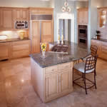 Private Residence, Chapel Hill. Verde San Francisco granite was selected for this kitchen due to its soft green-gray tones and beautiful, swirling movement. The slabs were just large enough to fabricate the island in one piece, eliminating the need for a seam. Decorative wood corbels ap